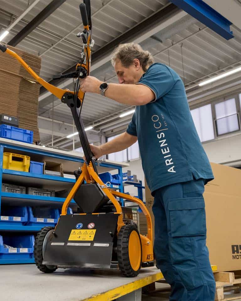 Factory worker of AriensCo EMEAA wearing their new turquise work wear inside their factory in Bühlertann, Germany